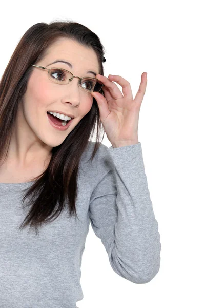 Surprised woman holding her glasses — Stock Photo, Image