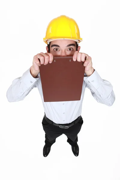 An architect hiding behind his clipboard. — Stock Photo, Image