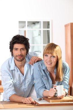 Couple having a coffee in a kitchen clipart