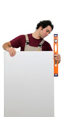 Workman using a spirit level clipart