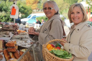 Women at the market together clipart