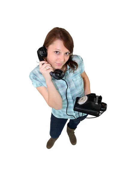 Junge Frau mit einem Retro-Handy — Stockfoto