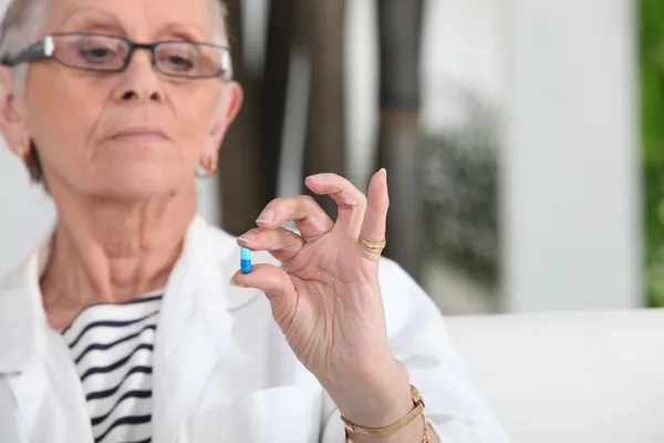 Donna anziana che prende pillole — Foto Stock