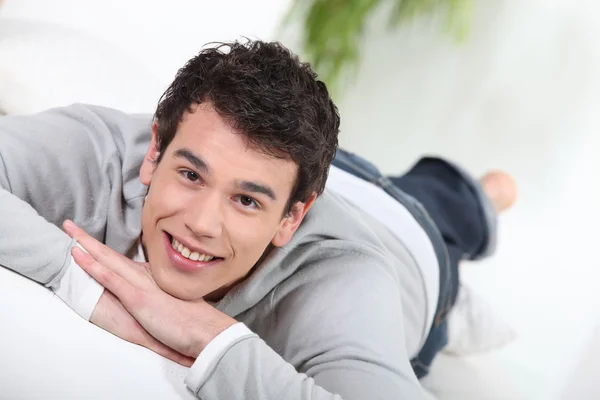 Young man relaxing on the sofa — Stock Photo, Image