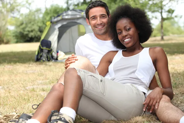 stock image Couple camping in a grassy field