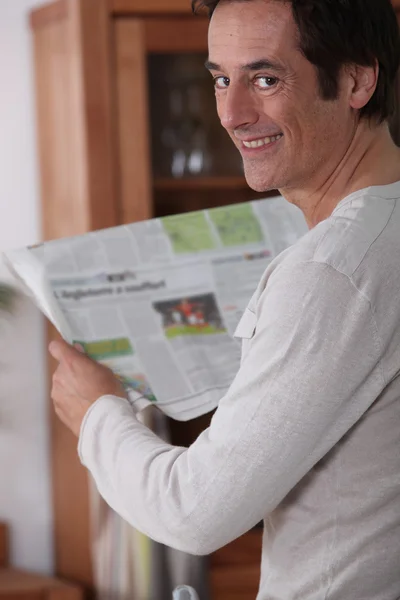 Man happy reading newspaper. — Stock Photo, Image