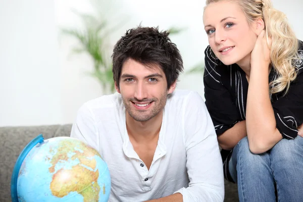 stock image Couple looking at the globe