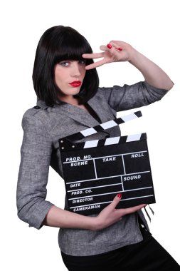 Stylish woman with a movie clap board clipart