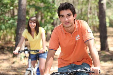 Young riding bikes clipart