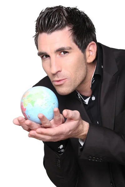 Young businessman with globe in his hands — Stock Photo, Image