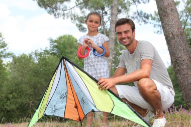 A father and his daughter with a kite clipart