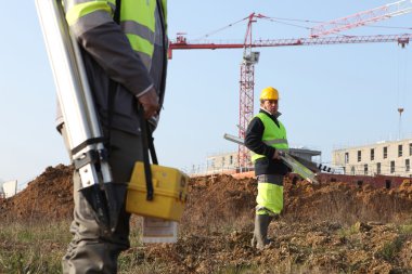 Surveyors on a construction site clipart