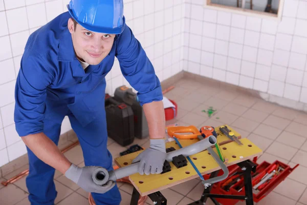 Young plumber with miscellaneous tools — Stock Photo, Image