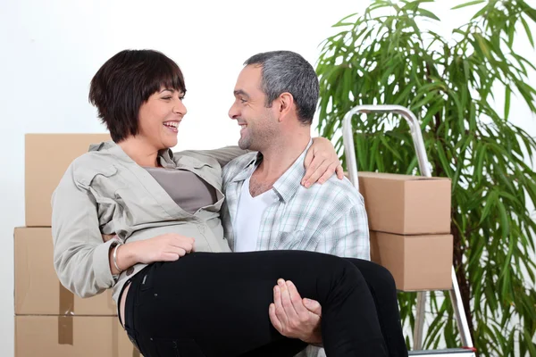 Man carrying his partner over the threshold of their new home — Stock Photo, Image