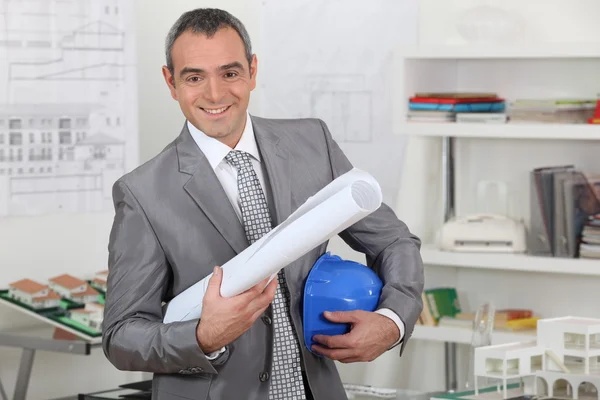 Architect with plans and hardhat — Stock Photo, Image