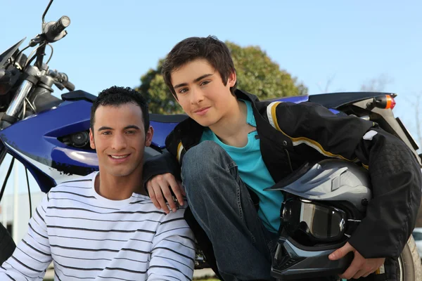 Father and son stood by motorbike — Stock Photo, Image