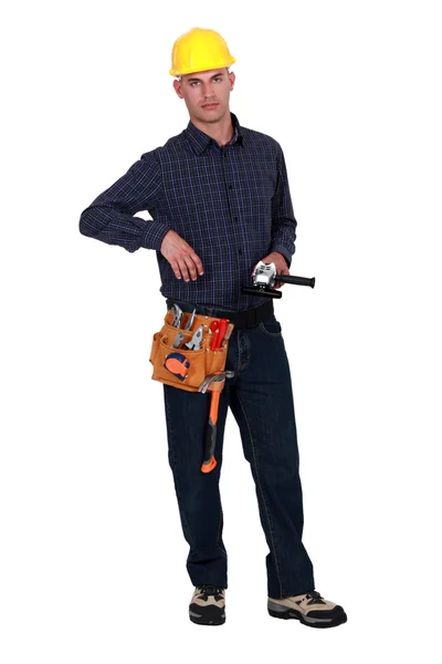 Un manitas sosteniendo una herramienta eléctrica . —  Fotos de Stock