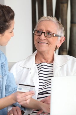 Mother and daughter shopping online clipart