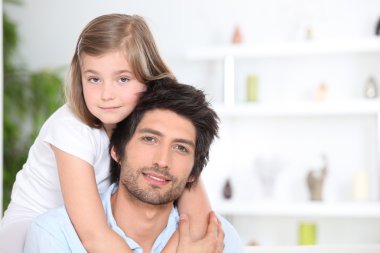 Little girl embracing her father clipart