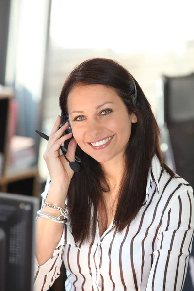 Smiling woman with a telephone headset — Stock Photo, Image