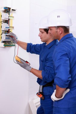 Two electricians performing checks clipart