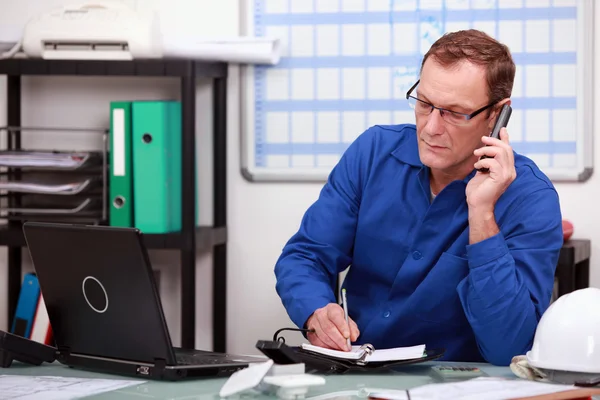 Mechanic on phone in office — Stock Photo, Image