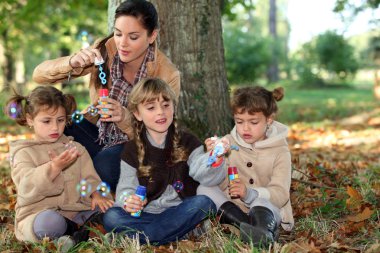 Children blowing bubbles clipart