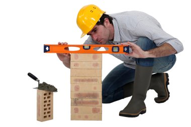 Tradesman using a spirit level clipart