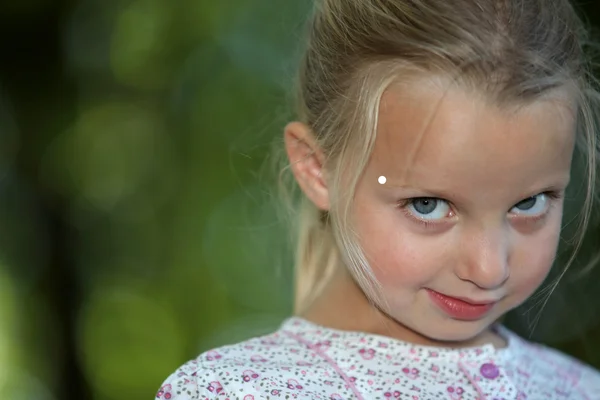 Blonde little girl looking shy — Stock Photo, Image