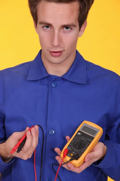 Young man with a multimeter — Stock Photo, Image