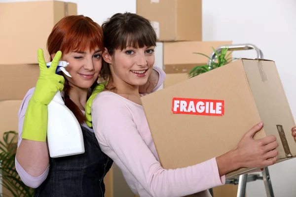 Duas namoradas arrumando seu novo apartamento — Fotografia de Stock