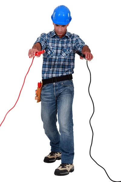 Laborer with battery clips in hands — Stock Photo, Image