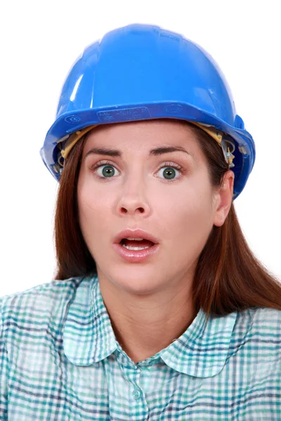 A scared female construction worker. — Stock Photo, Image
