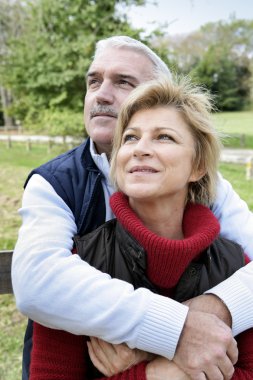 Mature couple in the countryside clipart