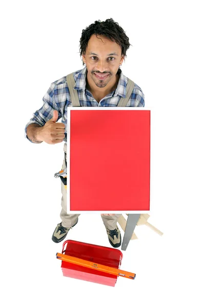 Thumbs up from a carpenter with a blank board — Stock Photo, Image
