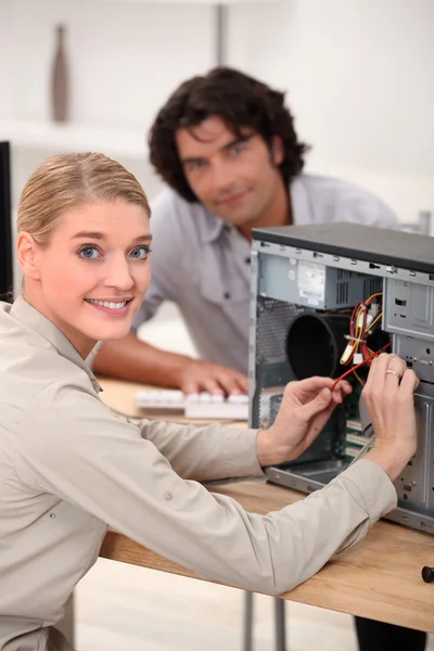Retrato de uma mulher que fixa um computador — Fotografia de Stock