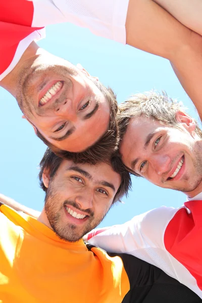 Players with heads together — Stock Photo, Image