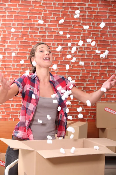 Stock image Woman throwing up packing peanuts