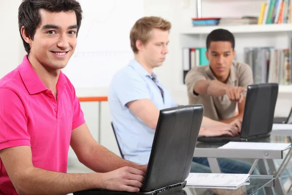 Student working at class on his laptop — Stock Photo, Image