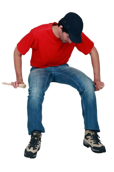 Tradesman sitting on an invisible object — Stock Photo, Image