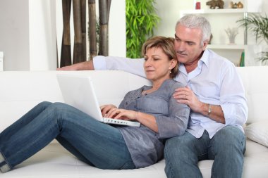 Couple sending an e-mail clipart