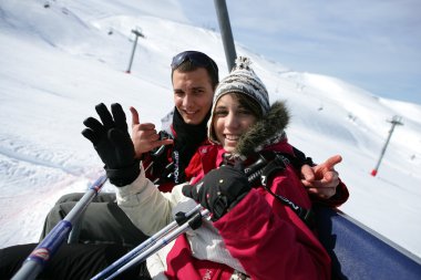 Duo at ski in ski lift clipart