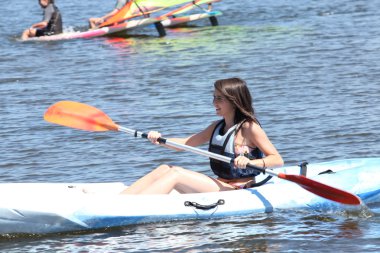 Woman on a kayaking excursion clipart