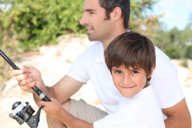 Father and son bonding during fishing trip clipart