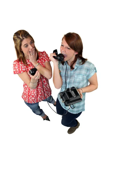 Girl screaming down an old fashioned phone — Stock Photo, Image