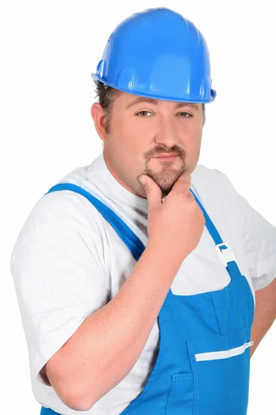 Construction worker in blue overalls and hardhat — Stock Photo, Image