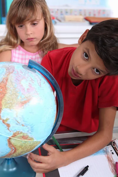 Les enfants à l'école avec un globe — Photo