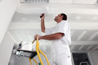 Tradesman painting a ceiling clipart