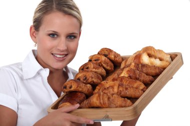 Blonde woman holding a platter of croissants clipart