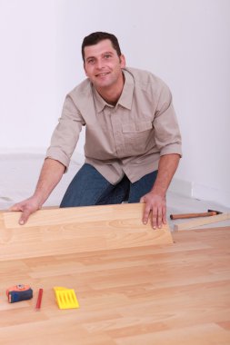 Laminate flooring being installed clipart